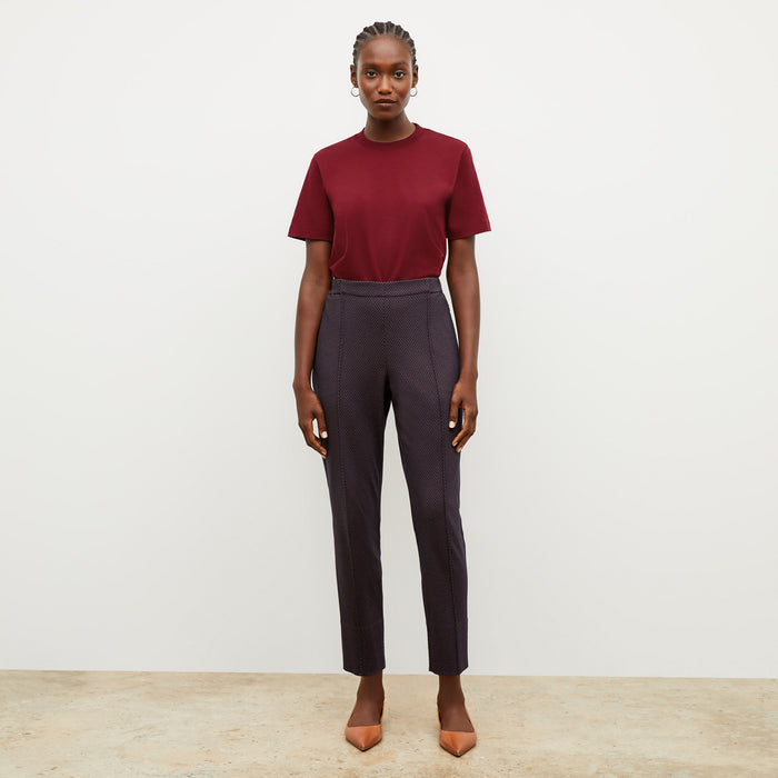 Front image of a woman wearing the leslie tshirt in maroon