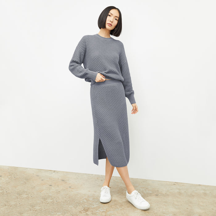 front image of a woman wearing the liam sweater in flint gray
