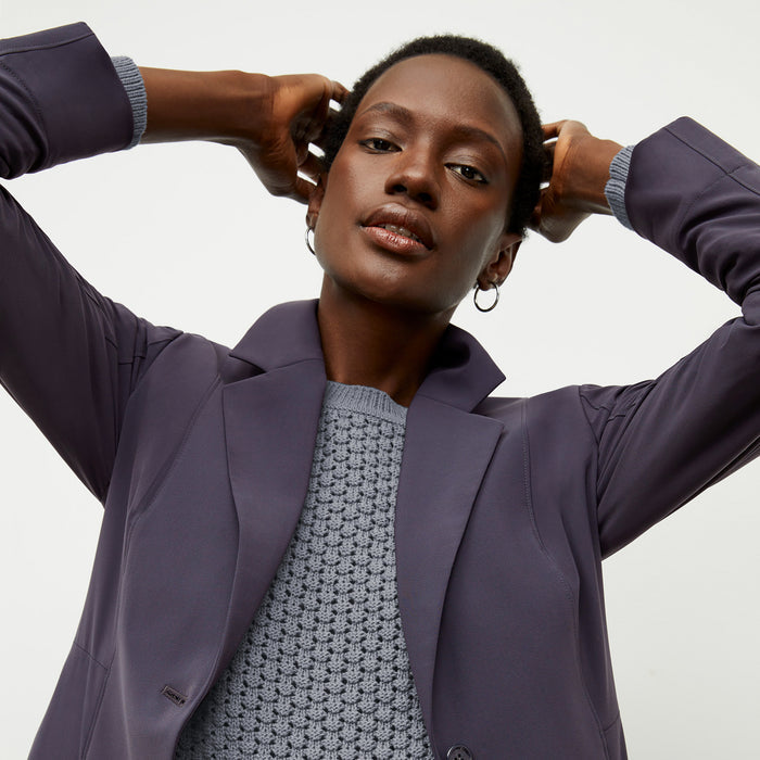 front image of a woman wearing the liam sweater in flint gray