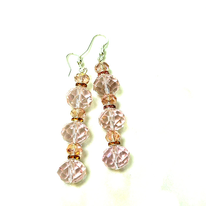 Light pink crystal drop earring with faceted bead detail and a sterling silver hook.