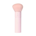 A tarte cosmetics pink makeup brush with soft, rounded bristles and a pink handle, on a white background.