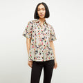 front image of a woman wearing the livingston top in rhythm print | Lead