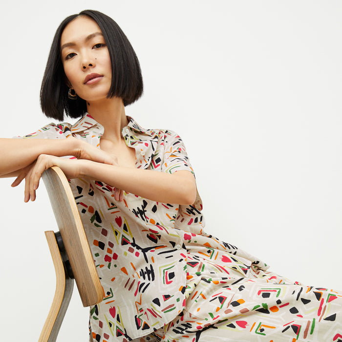 front image of a woman wearing the livingston top in rhythm print