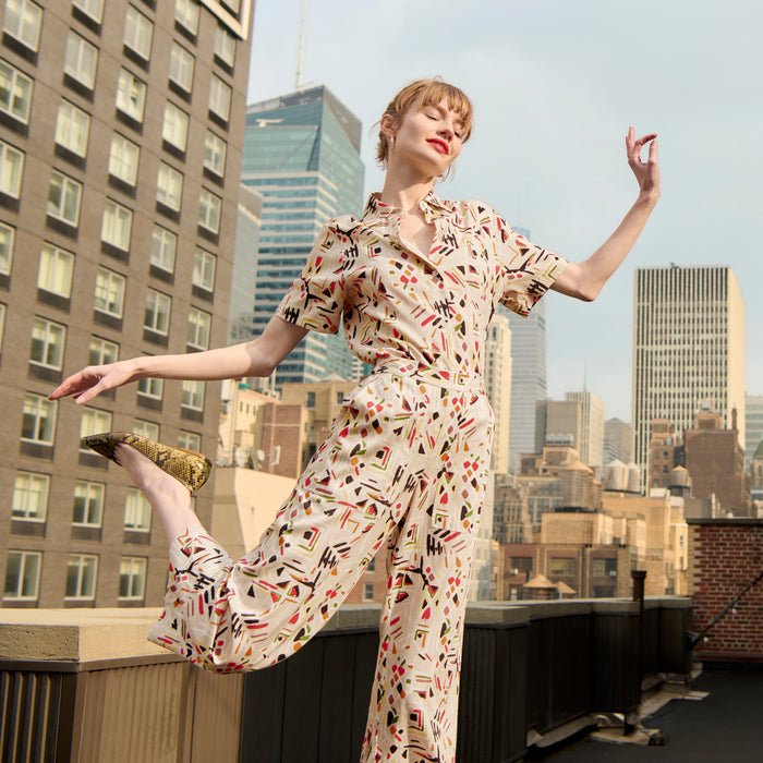 front image of a woman wearing the livingston top in rhythm print