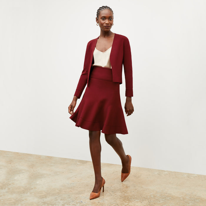 Front image of a woman wearing the luca skirt in maroon