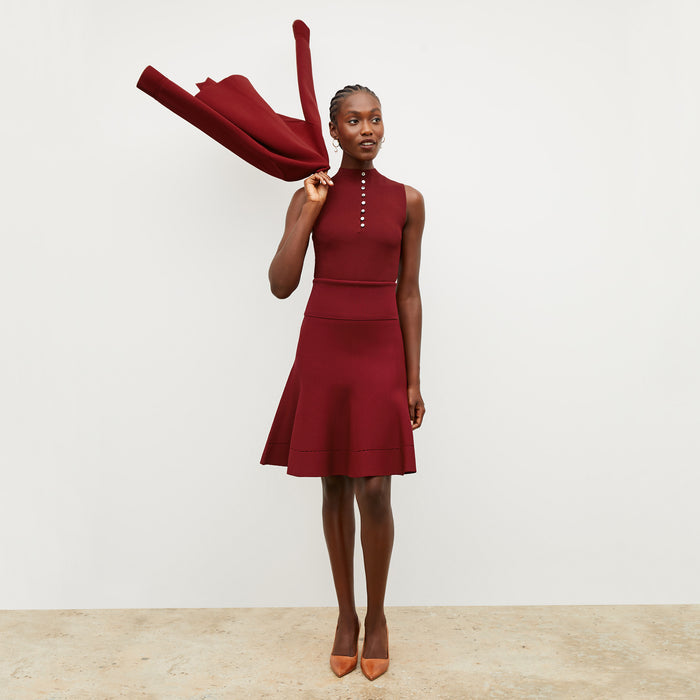 Front image of a woman wearing the luca skirt in maroon