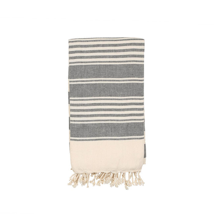 Grey and white towel folded with strips and tassels on a white background