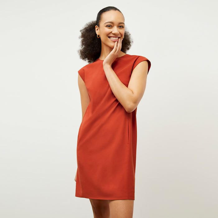Front image of a woman wearing the Maaza Dress in Blood Orange | Lead