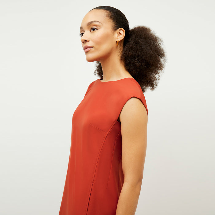 Front image of a woman wearing the Maaza Dress in Blood Orange