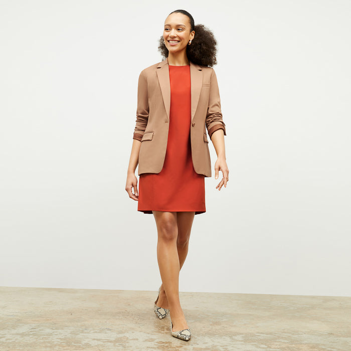 Front image of a woman wearing the Maaza Dress in Blood Orange