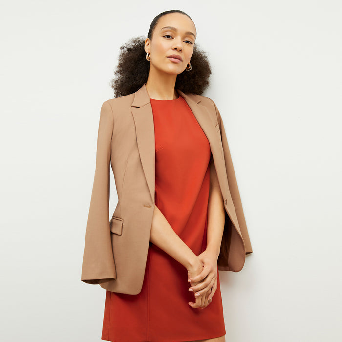 Front image of a woman wearing the Maaza Dress in Blood Orange