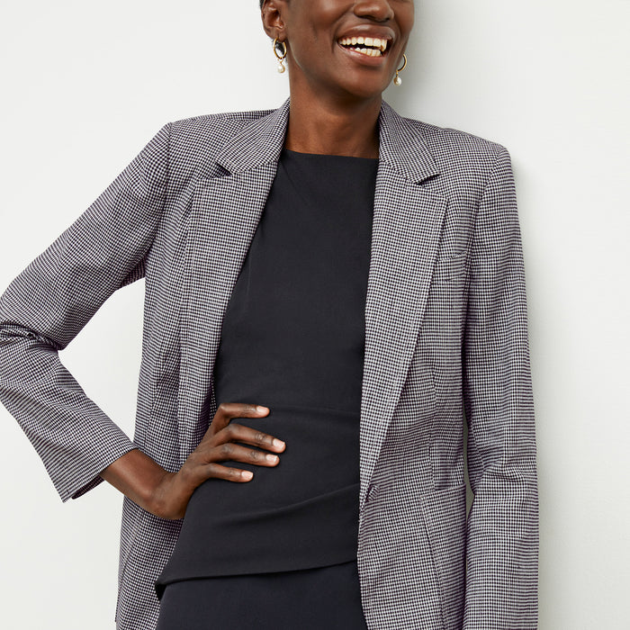 front image of a woman wearing the maisie dress in black