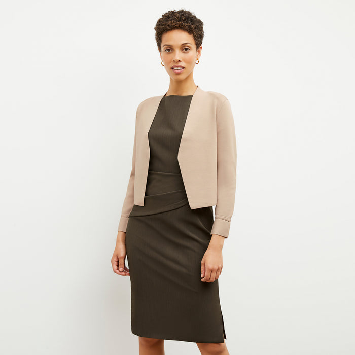 Front image of a woman wearing the Maisie Dress in Kale