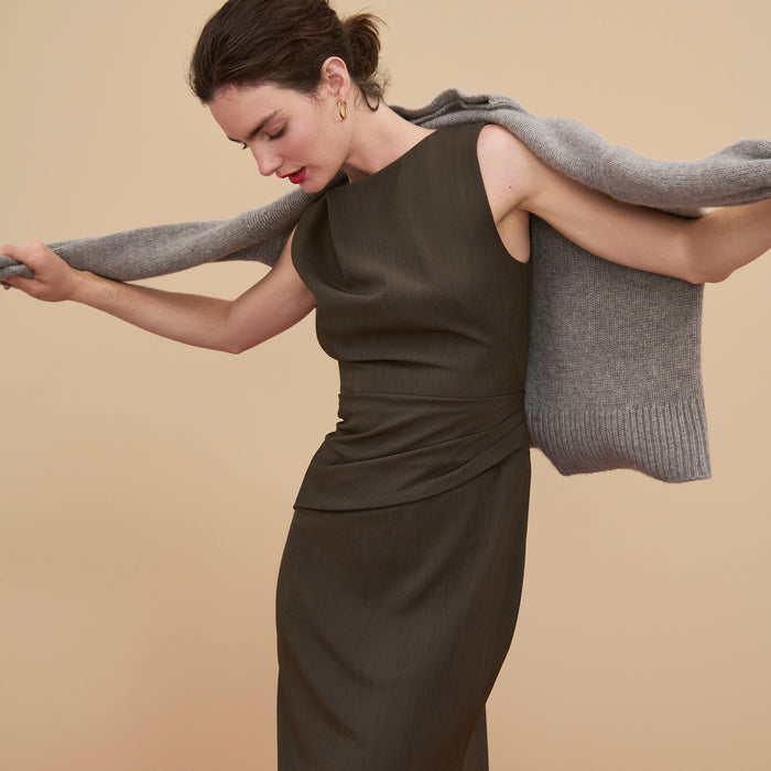 Front image of a woman wearing the Maisie Dress in Kale