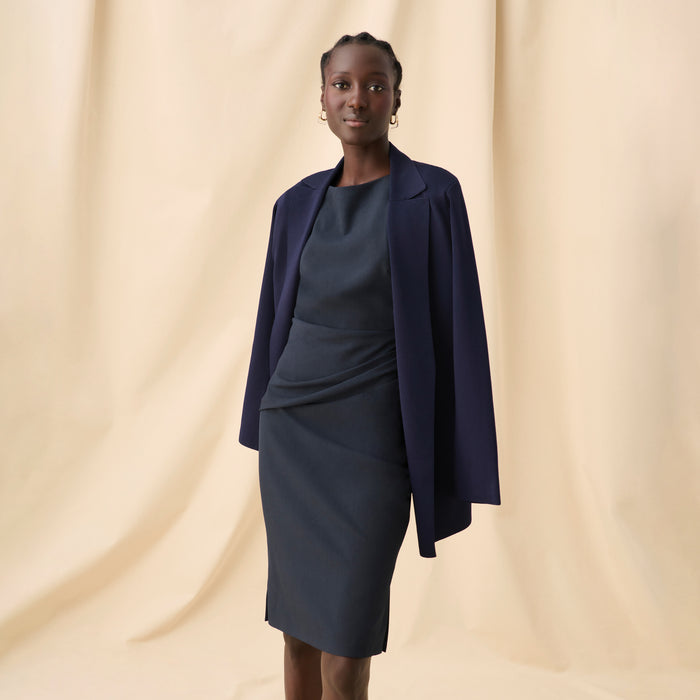 Front image of a woman in the maisie dress in midnight