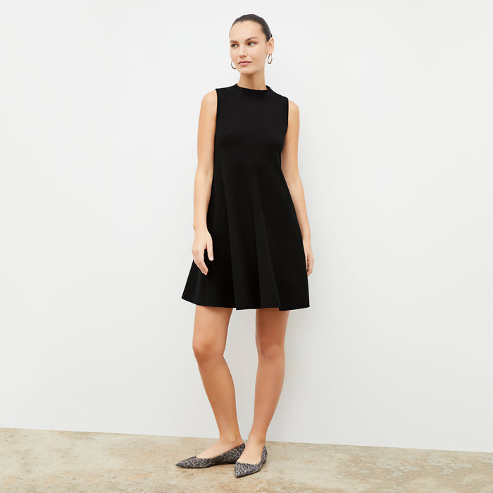 Front image of a woman in the malala dress in black