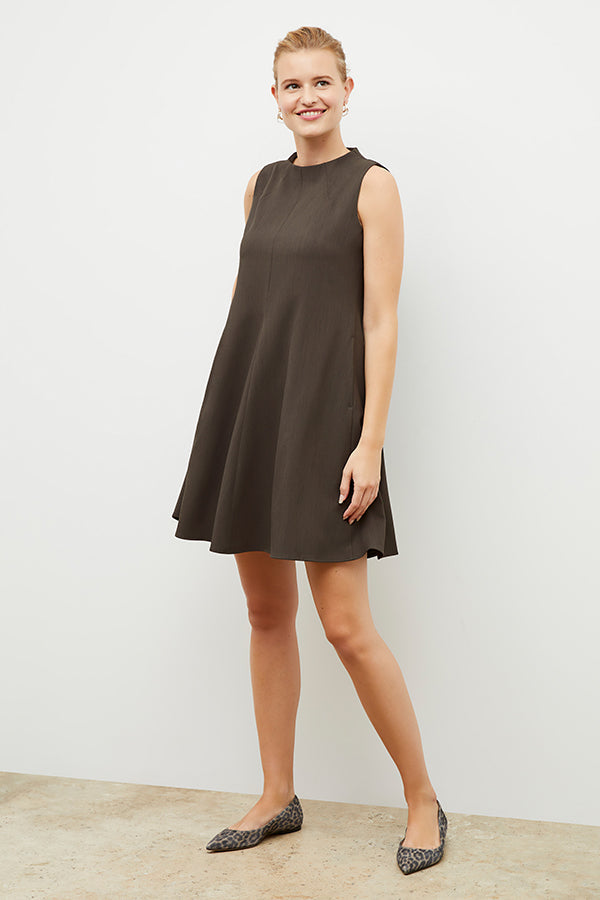 Front image of a woman wearing the malala dress in kale | Exclude | Grid Hover