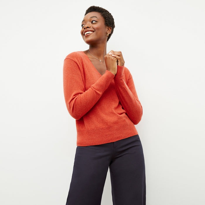 Front image of a woman wearing the martha sweater in papaya | Lead