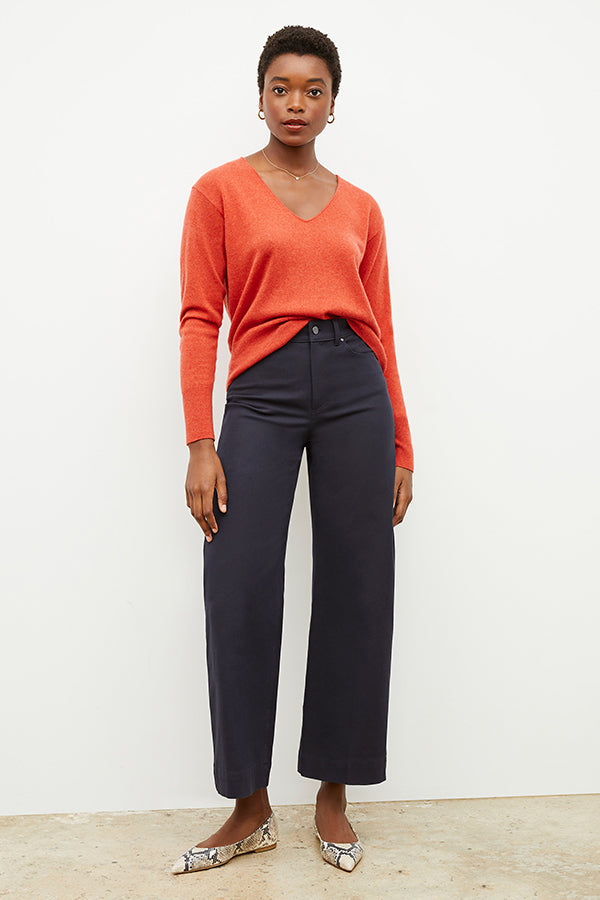 Front image of a woman wearing the martha sweater in papaya | Exclude