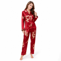 Women's burgundy matching couple pajamas with gold dragon and phoenix print, glossy long-sleeve top and full-length pants.