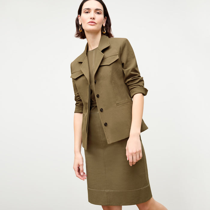 front image of a woman wearing the maude dress in oregano