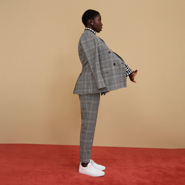 Side image of a woman wearing the mejia pant in plaid sharkskin
