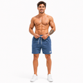 Men's blue corduroy shorts shown front facing while a male model adjusts the drawstring waist on a clean white studio background.