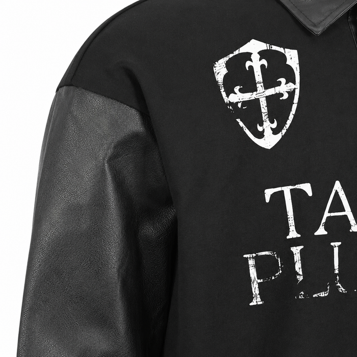Close view of the men's black graphic polo body fabric, sleeve surface, seam construction and distressed white chest print.