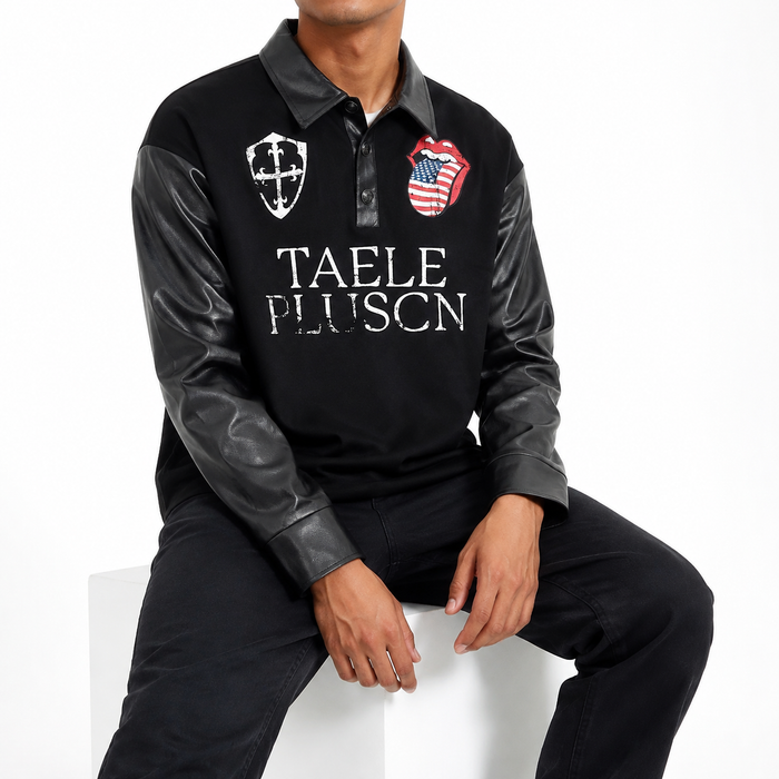 Men's black graphic long sleeve polo shirt on a seated male model, showing the front print, collar, sleeves and cuffs.