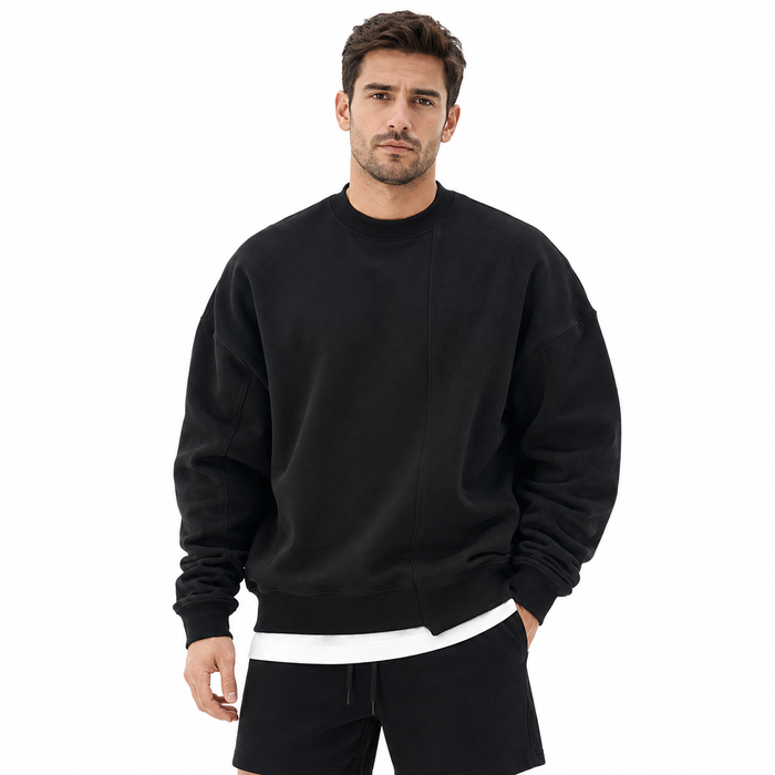 Men's black loose round neck sweater front view with long sleeves, ribbed trim and visible front seam detail.