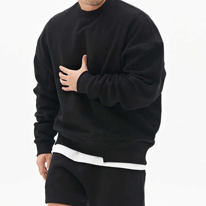 Original men's black round neck sweater front view with loose fit, long sleeves and layered white hem.