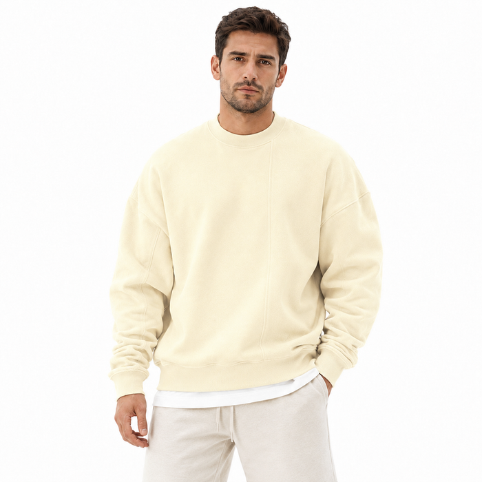 Men's cream loose round neck sweater front view with long sleeves, dropped shoulders and ribbed trim.