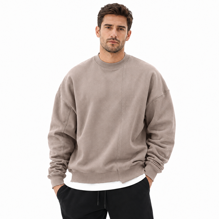 Men's taupe loose round neck sweater front view with long sleeves, front seam detail and ribbed trim.