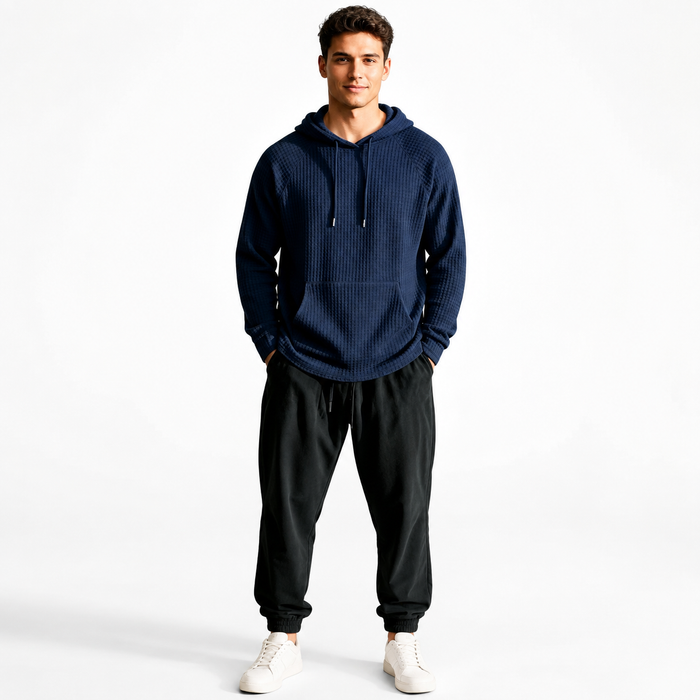 Men's navy waffle knit hoodie on male model, full studio hero view on white background.