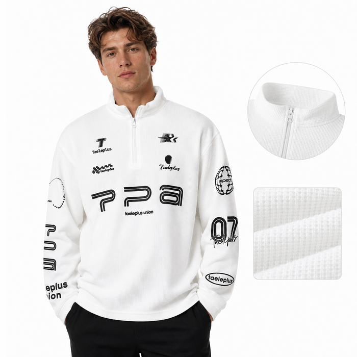 Men's waffle knit long sleeve shirt in white on male model with zip neck and printed graphic details.