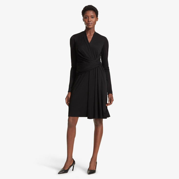 Front image of a woman standing wearing the Morgan dress in Black | Lead