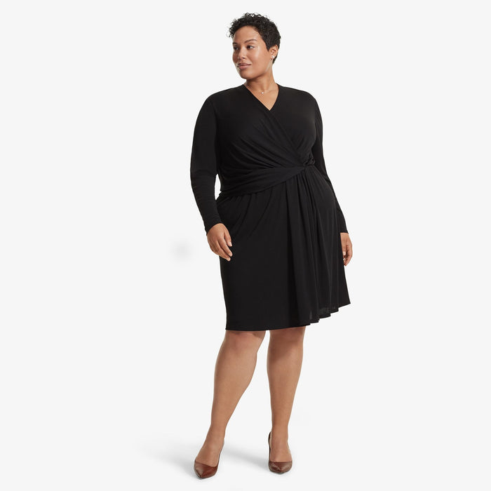 Front image of a woman standing wearing the Morgan dress in Black