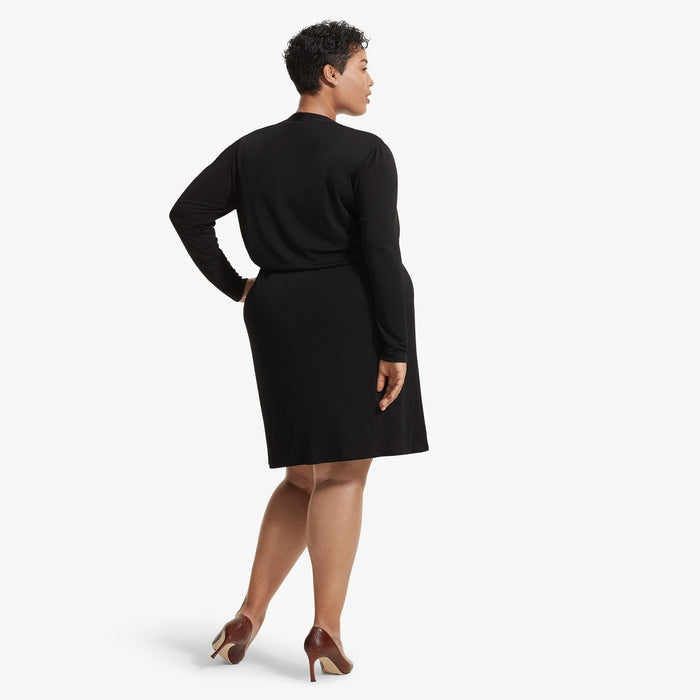 Back image of a woman standing wearing the Morgan dress in Black
