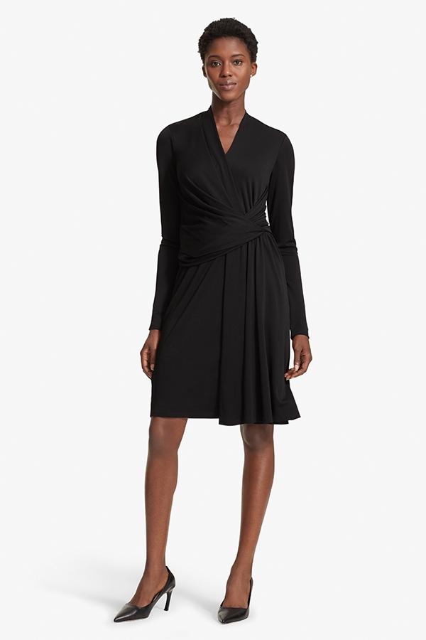 Front image of a woman standing wearing the Morgan dress in Black | Grid | Exclude