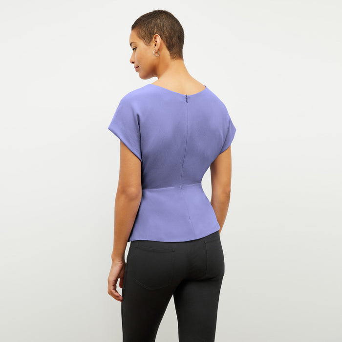 Back image of a woman wearing the Nejvi Top in Iris