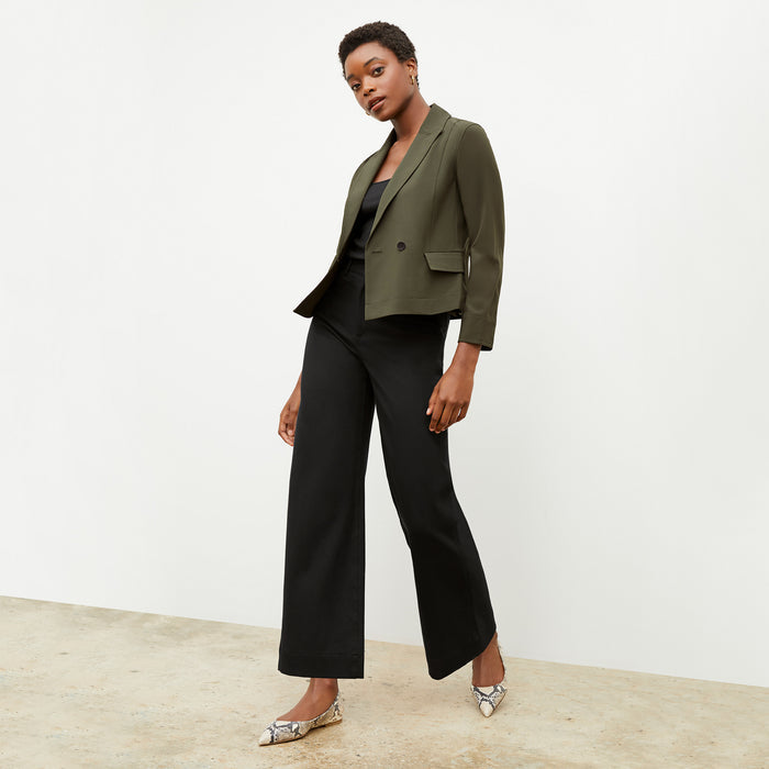 Front image of a woman wearing the nia jacket in olive