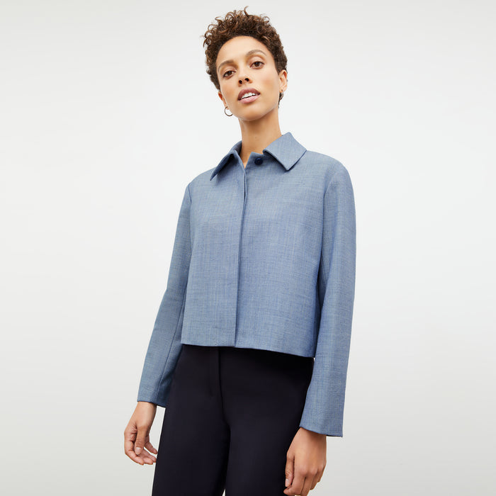Front image of a woman wearing the nicky jacket in indigo and white
