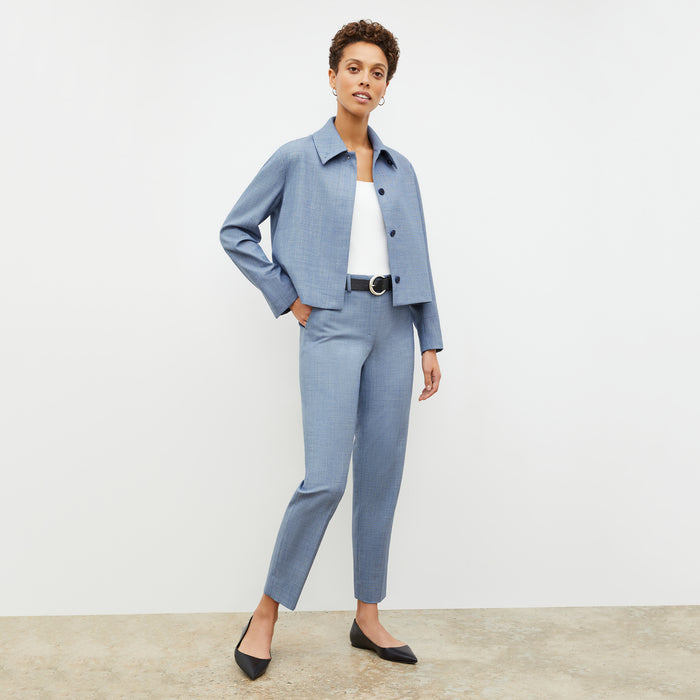 Front image of a woman wearing the nicky jacket in indigo and white