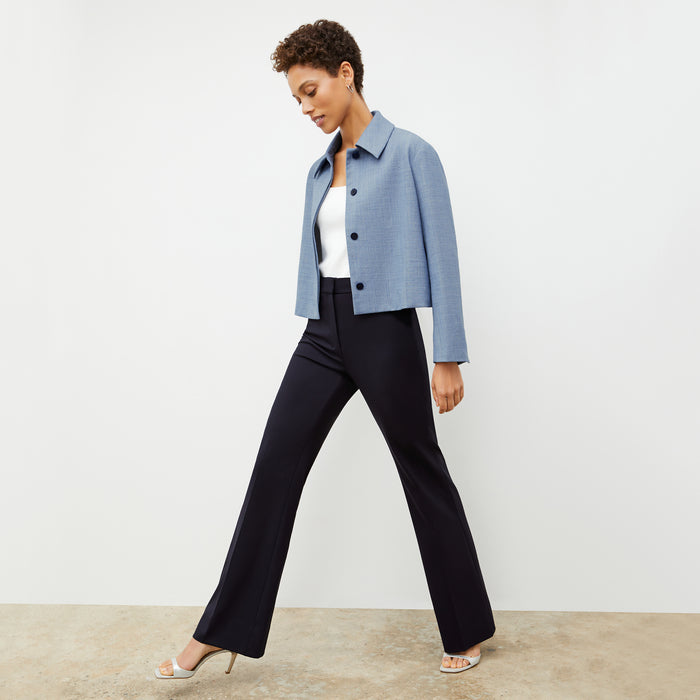 Front image of a woman wearing the nicky jacket in indigo and white