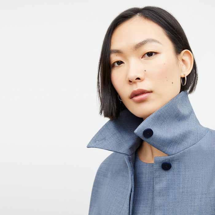 Front image of a woman wearing the nicky jacket in indigo and white