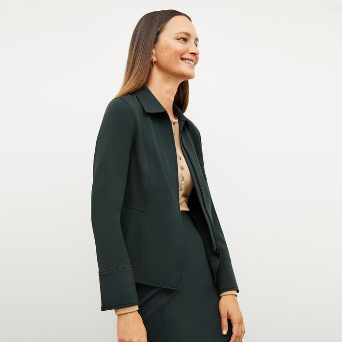 Image of a woman wearing the Nita Jacket in Forest