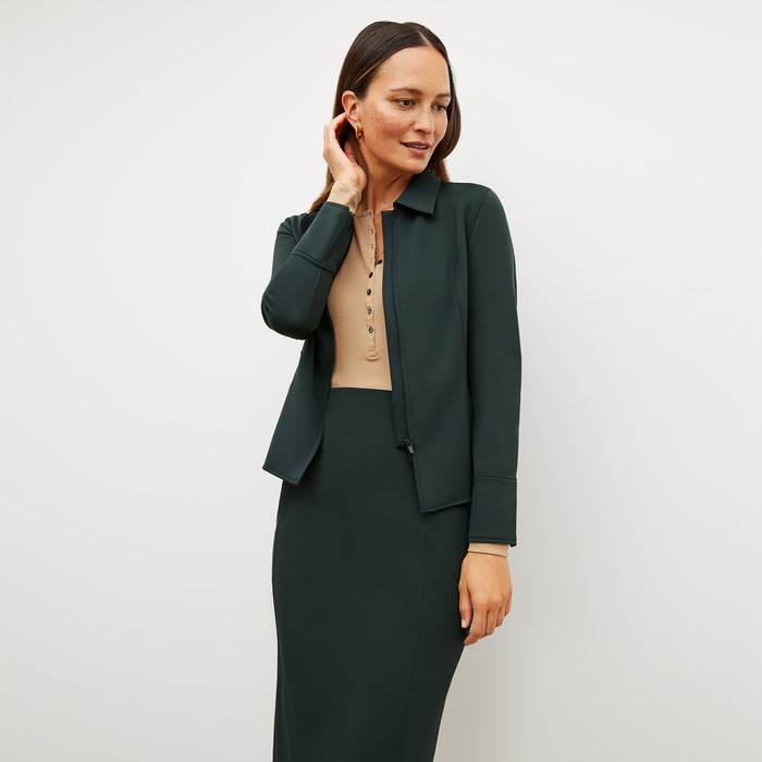 Image of a woman wearing the Nita Jacket in Forest