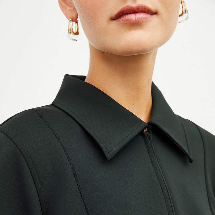 Image of a woman wearing the Nita Jacket in Forest