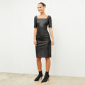 Front image of a woman wearing the noa dress in black | Lead