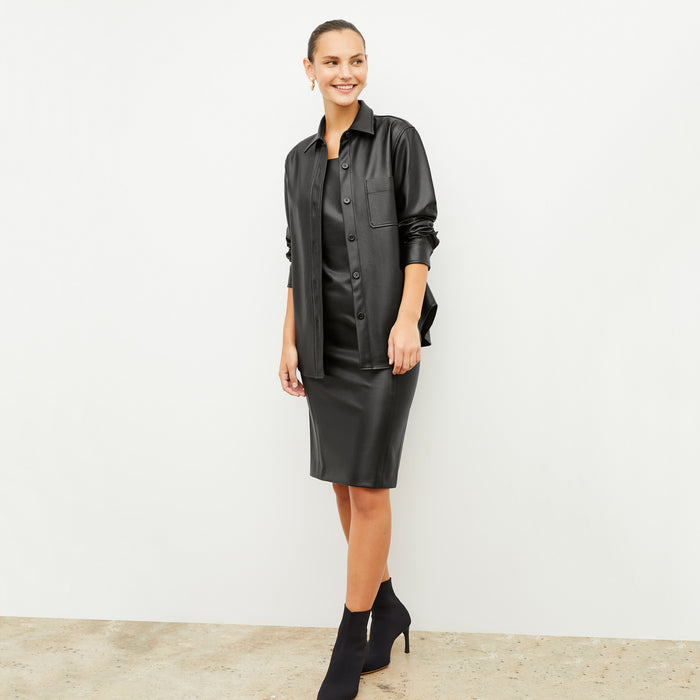 Front image of a woman wearing the noa dress and sierra shacket in black